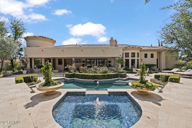 view of pool with an in ground hot tub