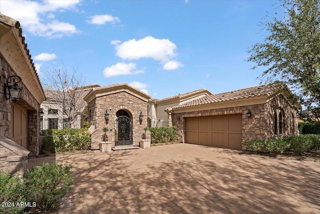 mediterranean / spanish-style home with a garage