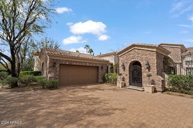 mediterranean / spanish home with a garage