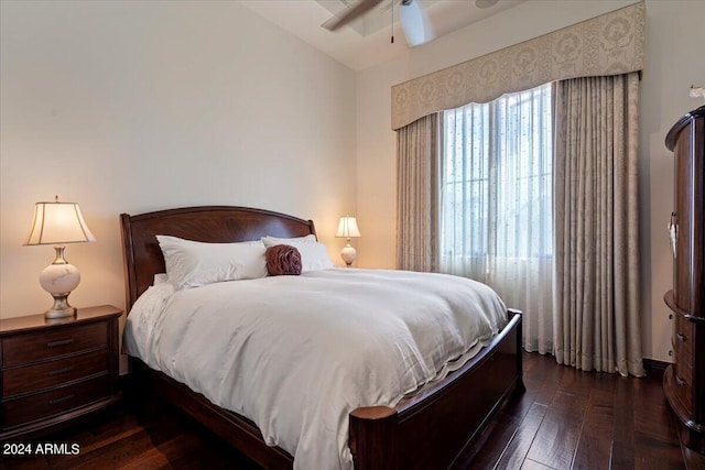 bedroom featuring ceiling fan, dark hardwood / wood-style flooring, and lofted ceiling