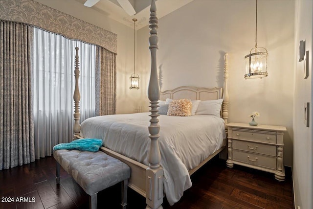 bedroom with dark hardwood / wood-style flooring and a notable chandelier