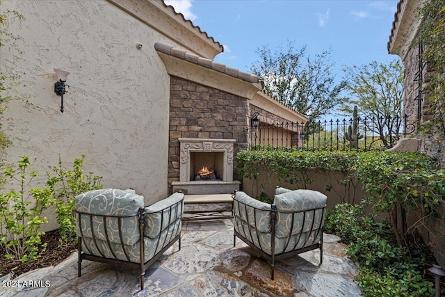 view of patio / terrace with an outdoor stone fireplace