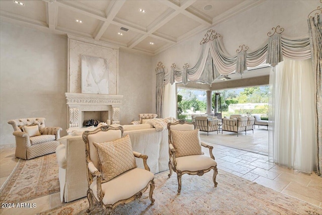 living area featuring a high end fireplace, coffered ceiling, crown molding, a towering ceiling, and beam ceiling