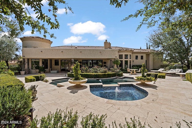 view of swimming pool with a patio area and an in ground hot tub