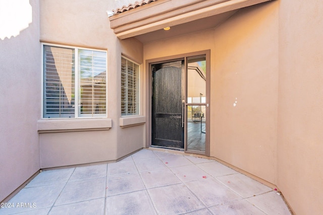 property entrance featuring a patio area