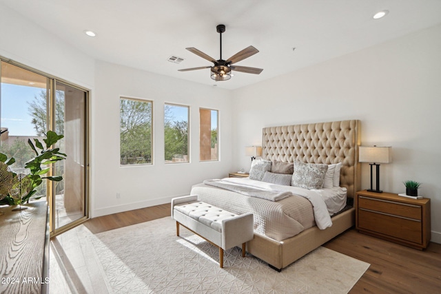 bedroom with access to exterior, ceiling fan, and hardwood / wood-style floors