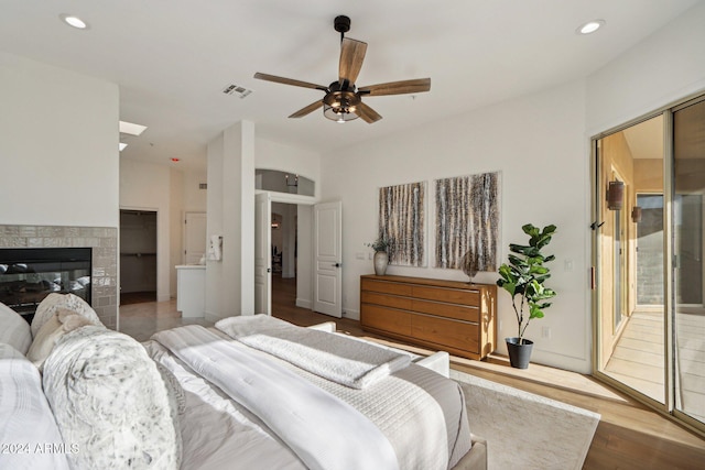 bedroom with hardwood / wood-style floors, a closet, and ceiling fan