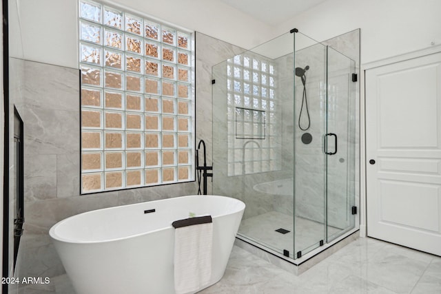 bathroom featuring separate shower and tub and a wealth of natural light