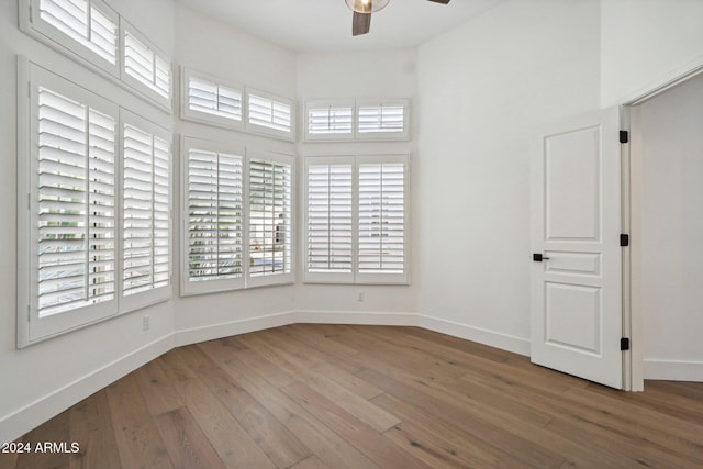 empty room featuring ceiling fan and hardwood / wood-style flooring