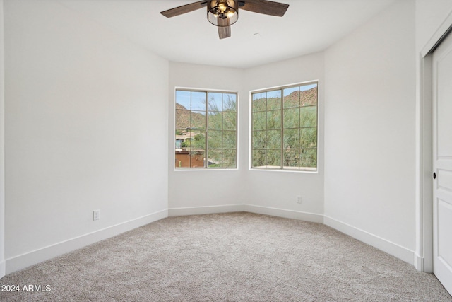 unfurnished bedroom featuring carpet flooring, ceiling fan, and a closet