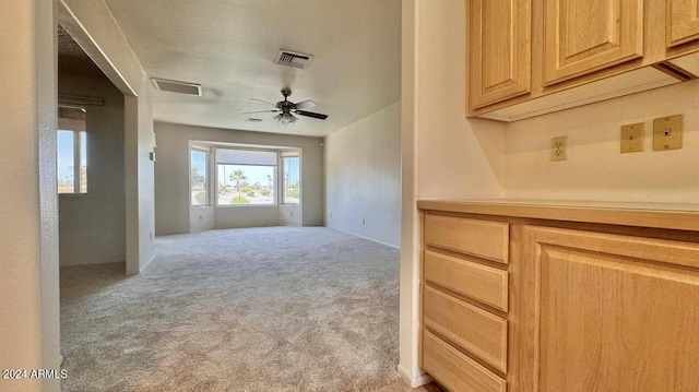 hallway with light colored carpet