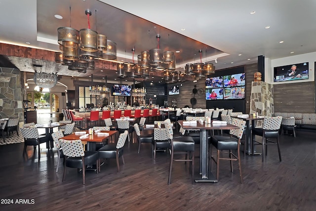 dining space with a tray ceiling and hardwood / wood-style floors