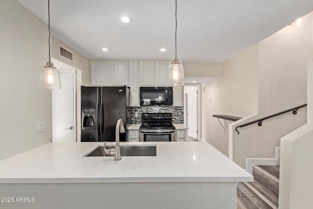 4901 S Calle Los Cerros Dr Unit 220, Tempe, AZ 85282 - kitchen featuring black appliances, a sink, recessed lighting, decorative backsplash, and hanging light fixtures