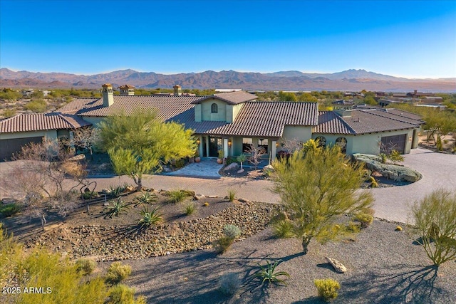 view of front of property featuring a garage and a mountain view