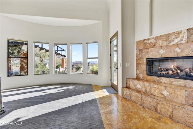 living room featuring a tiled fireplace