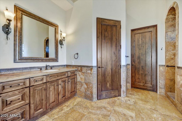 bathroom with tile walls and vanity