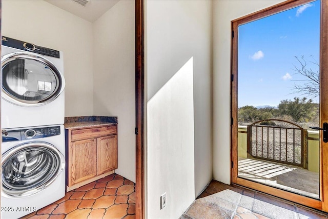 laundry area featuring stacked washer and clothes dryer