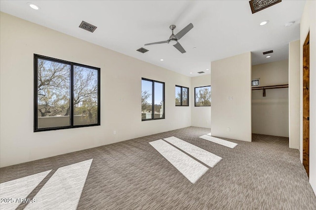 unfurnished bedroom with ceiling fan, a closet, and carpet