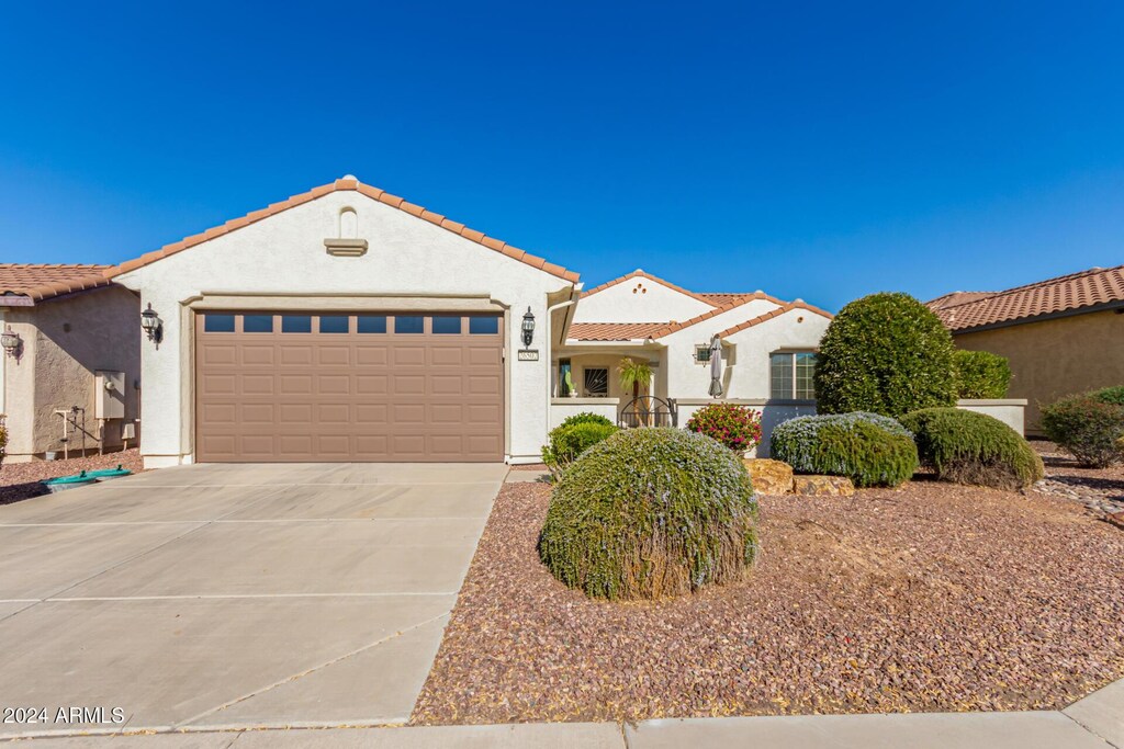 mediterranean / spanish-style house with a garage