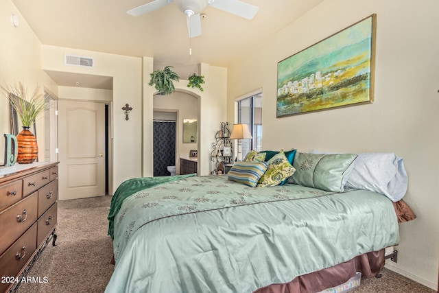 bedroom with carpet flooring, ceiling fan, and connected bathroom