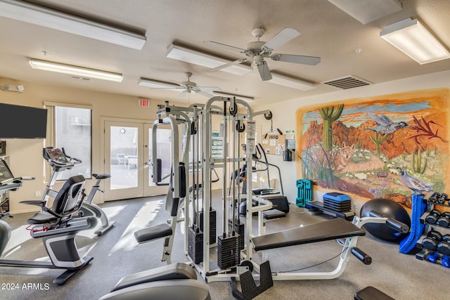 exercise room with ceiling fan and french doors