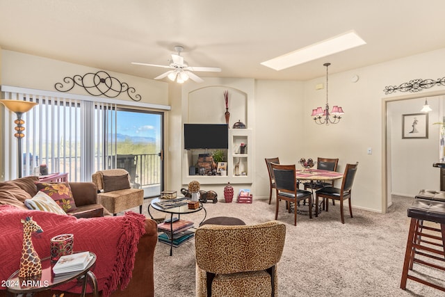 living room featuring carpet flooring and ceiling fan with notable chandelier