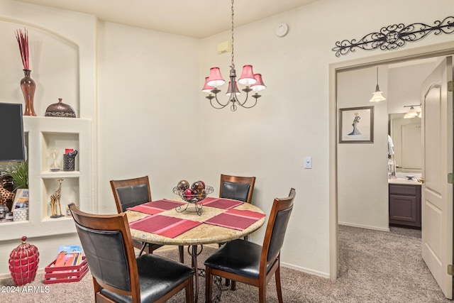 carpeted dining space featuring a chandelier