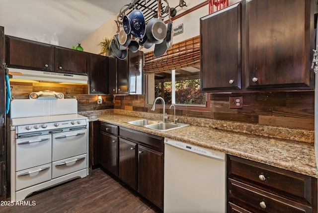 kitchen with tasteful backsplash, a sink, dark brown cabinets, white appliances, and under cabinet range hood