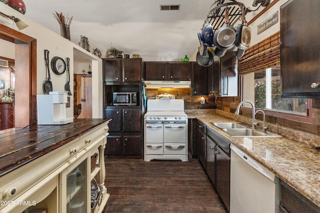 kitchen featuring visible vents, range with two ovens, dishwasher, stainless steel microwave, and a sink