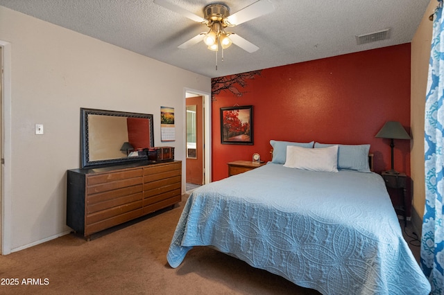 bedroom featuring a textured ceiling, ceiling fan, carpet flooring, visible vents, and baseboards