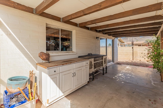 view of patio / terrace with exterior kitchen and fence