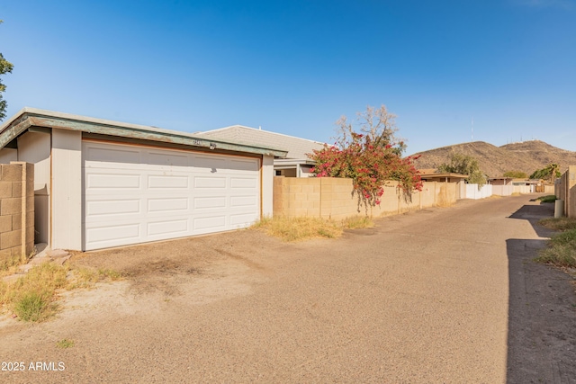 garage with fence and a mountain view