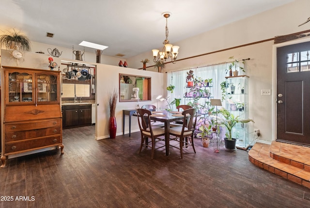 dining area featuring baseboards, visible vents, a chandelier, and dark wood-style flooring