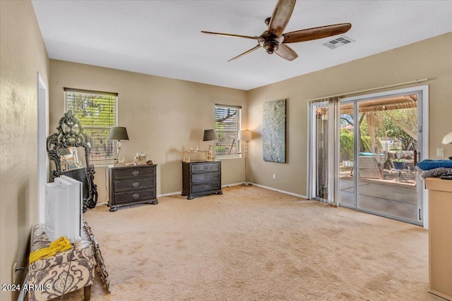 interior space featuring light colored carpet and ceiling fan