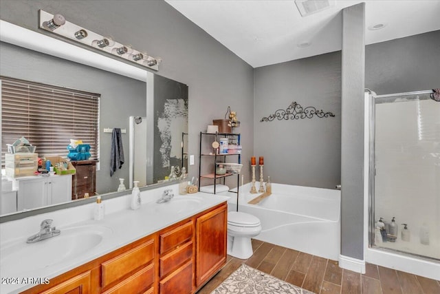 full bathroom with hardwood / wood-style floors, vanity, independent shower and bath, and toilet