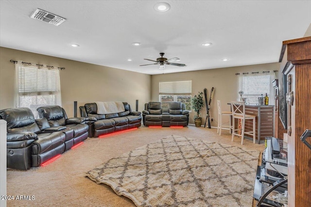 carpeted living room with ceiling fan