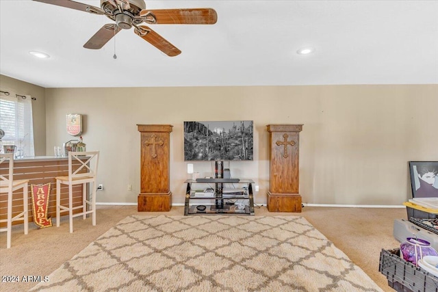 living room featuring carpet flooring and ceiling fan