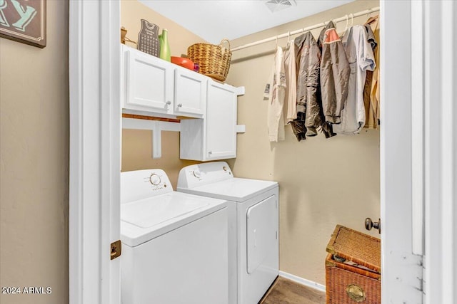 laundry room featuring cabinets and washing machine and clothes dryer