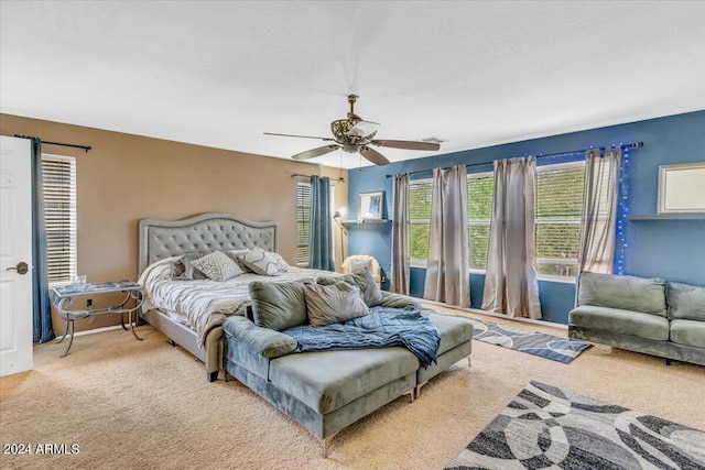 bedroom featuring light colored carpet and ceiling fan