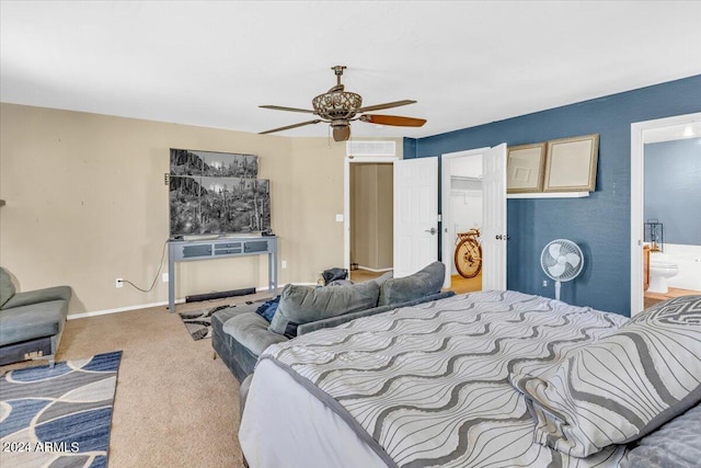 bedroom with ensuite bath, ceiling fan, and carpet floors