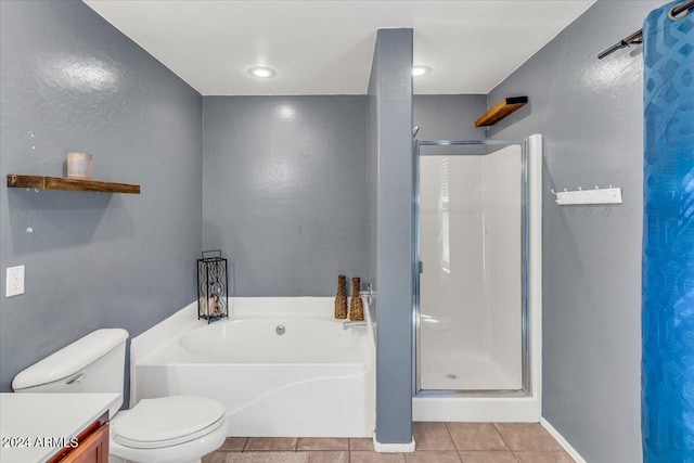 full bathroom featuring tile patterned flooring, vanity, separate shower and tub, and toilet