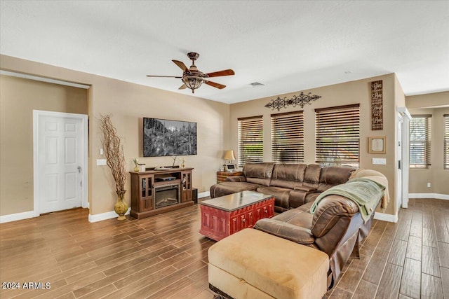 living room featuring hardwood / wood-style floors, a textured ceiling, plenty of natural light, and ceiling fan