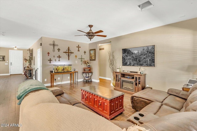 living room featuring ceiling fan and wood-type flooring