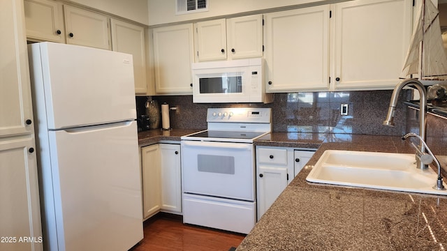 kitchen featuring white cabinets, white appliances, sink, and backsplash