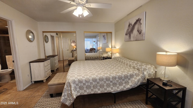 tiled bedroom with ceiling fan, connected bathroom, and two closets