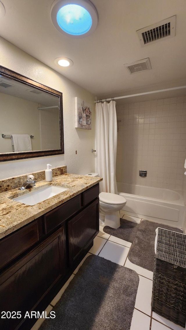 full bathroom featuring tile patterned flooring, toilet, vanity, and shower / bath combo with shower curtain