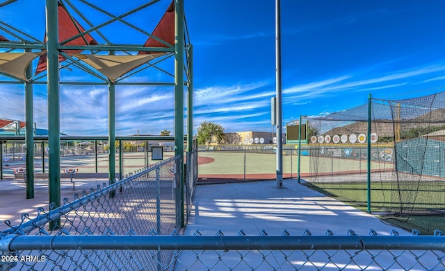 view of property's community featuring tennis court