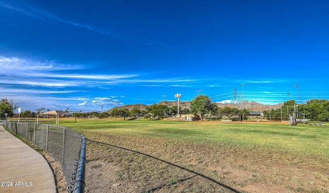 view of property's community with a mountain view and a yard