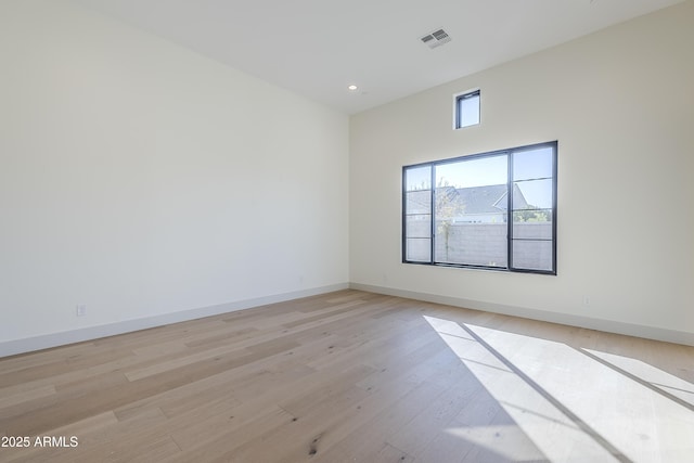 unfurnished room featuring light wood finished floors and baseboards