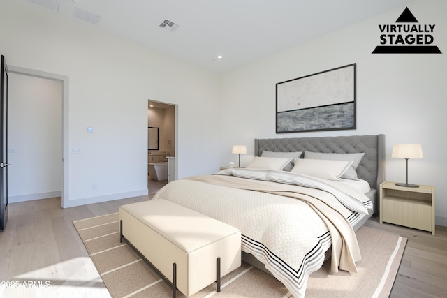 bedroom with light wood-style floors, baseboards, recessed lighting, and ensuite bath